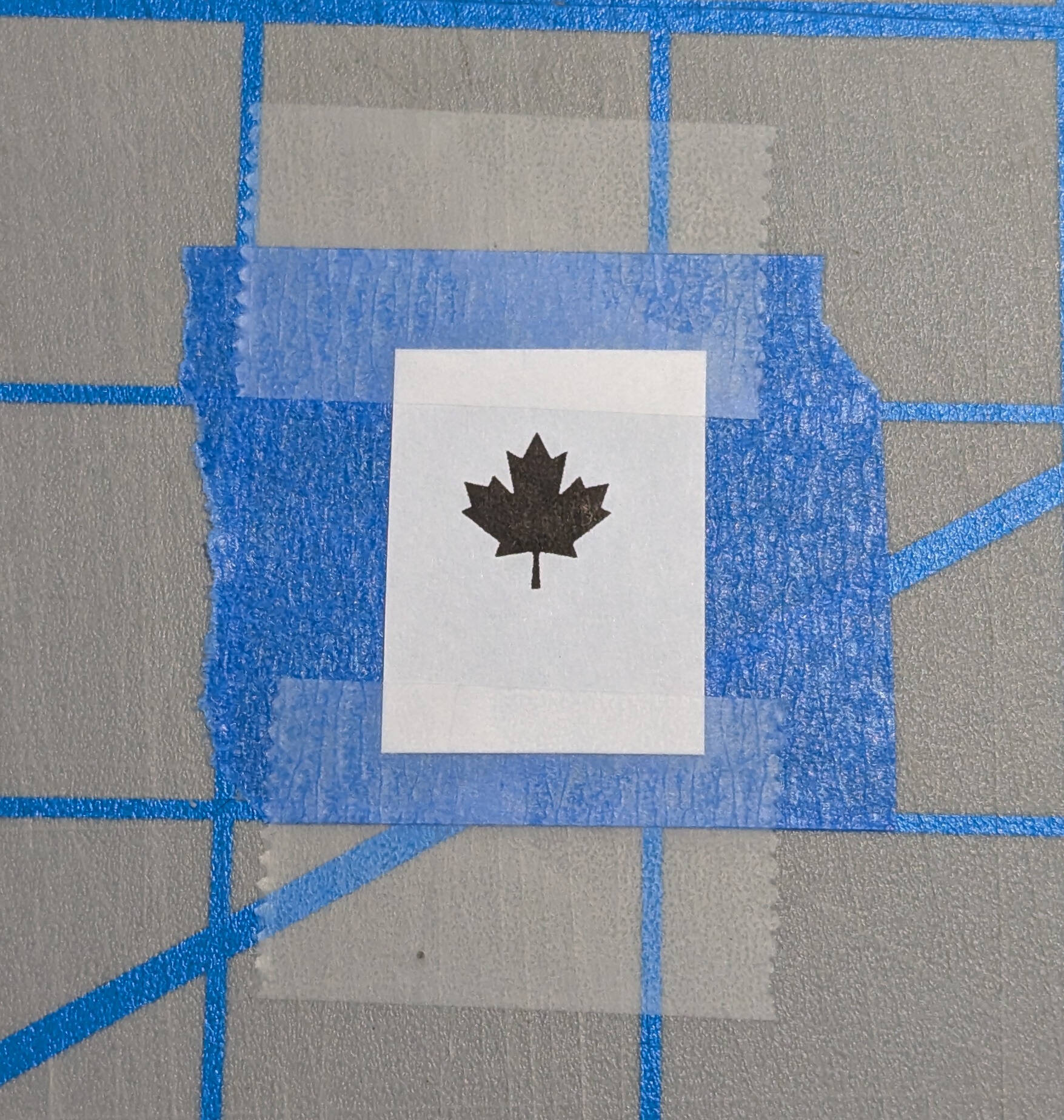 printed paper stencil taped overtop of painters tape